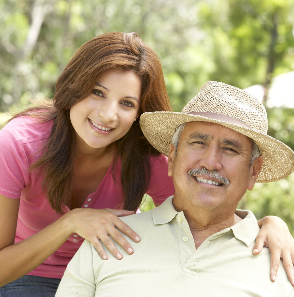 Senior Hispanic Man With Adult Daughter In Garden